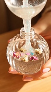 Cute Ornaments You’ll Need: Clear plastic or glass ornaments (with removable tops) Clear glue or glitter glue (depending on the sparkle you want) Warm water Fine glitter (pink, gold, and iridescent tones) Small artificial flowers, dried flowers, or sequins Optional: 1 drop of food coloring for a soft tint Small funnel or squeeze bottle Stir stick or skewer Instructions: 1. Prepare Your Ornament: Remove the top and make sure the ornament is clean and dry inside. 2. Mix Your Calm Solution: In a sm