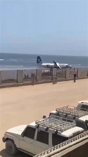 Passengers exited a crashed Fokker 50 aircraft along the shoreline of Somalia’s capital on February 10 after the plane developed a technical problem shortly after takeoff. All 55 passengers and crew survived and were evaluated at a nearby hospital, Somalia’s Civil Aviation Authority said. | Reuters