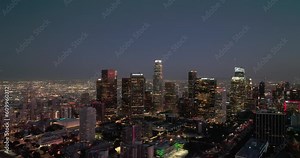 Night aerial view of downtown Los Angeles, California. Downtown Los Angeles at night from drone. Night illuminated flight over Los Angeles city downtown panorama. Los Angeles night buildings skyline.