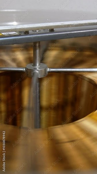 Organic honey frames spinning in the centrifuge apparatus. Special device for extracting honey at bee farms at work. Vertical video