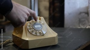 dialing an old style phone scale dial. Antique beige telephone. Rotating all numbers with your finger.