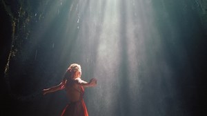 Happy woman dancing in waterfall cave splashing water wearing beautiful dress enjoying nature dance feeling spiritual freedom 4k | Premium Stock Video Footage