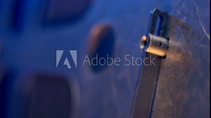 In movie theater, old vintage projector spins reel of 16mm film in extreme close-up. retro appliance is still in working order, adding to charm of the experience.