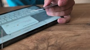 Man hand enters personal data on tablet screen holding bank card. Ease of use, and modern solutions for financial transactions.