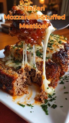 Italian Mozzarella‑Stuffed Meatloaf (Cheesy and Saucy) Comfort classic, Italian style: juicy meatloaf with a molten mozzarella center and a tangy tomato glaze. Yield and time Servings: 6–8 Prep: 15 minutes Cook: 55–65 minutes Rest: 10 minutes Ingredients 1½ lb ground beef (or 1 lb beef ½ lb Italian sausage) 1 small onion, finely minced 2 garlic cloves, minced ¾ cup breadcrumbs (panko or Italian‑style) ½ cup milk 1 egg ¼ cup grated Parmesan 2 tbsp chopped parsley, plus more for topping 1 tsp Ital