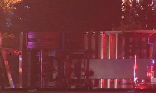 Police investigating after tractor-trailer rolls over on I-93 in Woburn