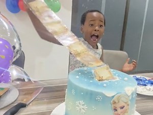 Child's priceless reaction to pulling money from cake