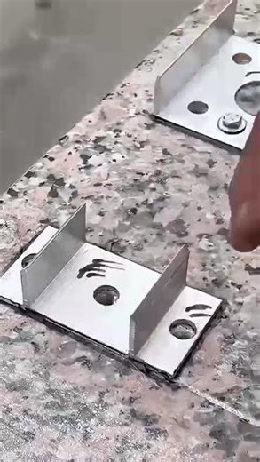 the process of making a locking bracket on a ceramic floor that is drilled to install bolts#shorts