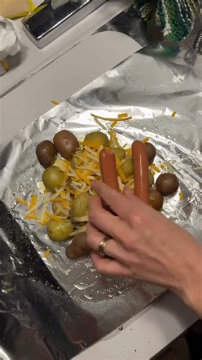 🌭🔥 Camping just got tastier with these Campfire Hot Dog & Potato Packets! 🏕️ Perfect for grilling too! Just wrap up Little Potatoes, hot dogs, cheese, and barbecue sauce in foil for an easy all-in-one meal! #CampfireCooking #EasyRecipes #HotDogPacket | The Little Potato Company