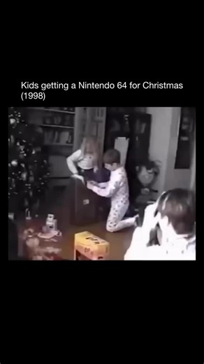 History Reported on Instagram: "1998: Few Christmas mornings hit harder than the moment kids tore open wrapping paper to find a brand-new Nintendo 64. The instant that familiar gray console appeared, living rooms exploded with pure, unfiltered joy. Screams, jumping, running in circles — the reaction was practically a rite of passage for an entire generation raised on Mario, Zelda, and the promise of 3D worlds waiting just beyond the power button.” “Parents watched with a mix of pride and amuseme
