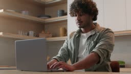 Concentrated Indian businessman typing computer working shopping...