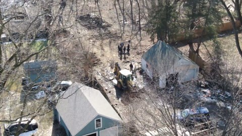 Police, excavator seen behind home in south Lansing