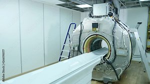 MRI scanner without upper plastic covering panels. MRI machine assembling and installation. Building of new modern hospital with MR-imaging unit in room. Long shot. 4k Stock Video