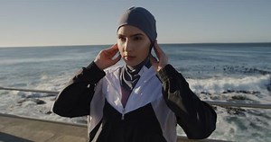 young woman runner confident muslim female enjoying healthy fitness lifestyle ready for running exercise wearing hijab sportswear on seaside morning run