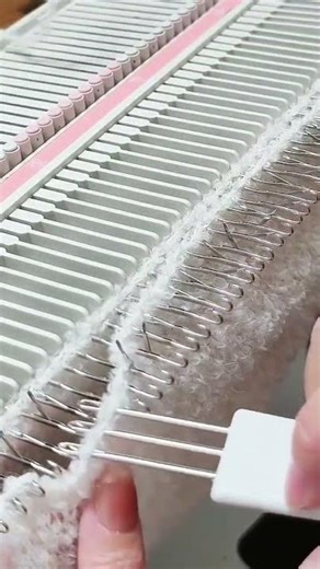 the process of knitting or weaving white fur cloth on small irons