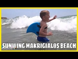 Kids playing on the beach . Hopping in the waves with Swimfin, Sunwing Makrigialos Beach. Video 2016