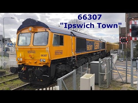 Class 66 GB Railfreight 66307 "Ipswich Town" ballast train Passing Oulton Broad North Level Crossing