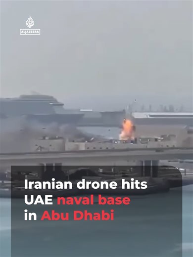 Video from Abu Dhabi captured the moment a second Iranian drone struck the Al Salam Naval Base. A fire was already burning from an earlier hit and what appears to be a cruise ship could be seen docked in the background. #News