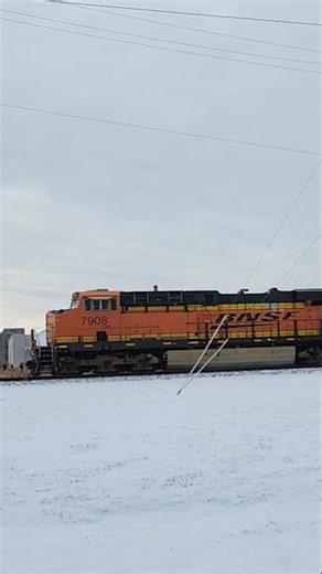CSX oil train with BNSF power passes through a crossing on a snowy day. 31826 #shorts #oil #fast