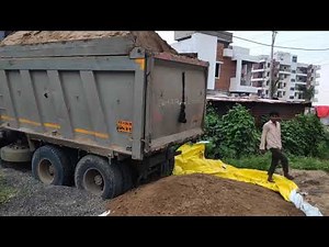 Truck dumping 1200 cubic feet of sand