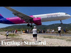 Terrifying moment a Wizz Air plane flies just metres above tourists’ heads at Greek airport