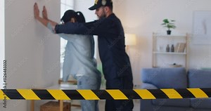 Crime scene barricade tape, yellow police line, safety warning, police officer, policeman making and processing arrest of young guilty woman, handcuffing dishonest criminal suspect, female prisoner