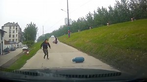 1M views · 6K reactions | A heroic woman surnamed Zhou ran to block a gas cylinder that was rolling down a slope towards a car in the city of Jingzhou in central China on May 1. The cylinder fell off a motorcycle that had collided with a car. Ms. Zhou said she heard a noise and came outside to investigate. When she saw what was happening, she sprinted to prevent a possible explosion. | CGTN | Facebook