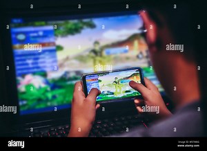 Young boy playing videogame on computer and having fun with a new game. Child enjoy video games with wireless controller sitting at his desk fully con Stock Photo - Alamy