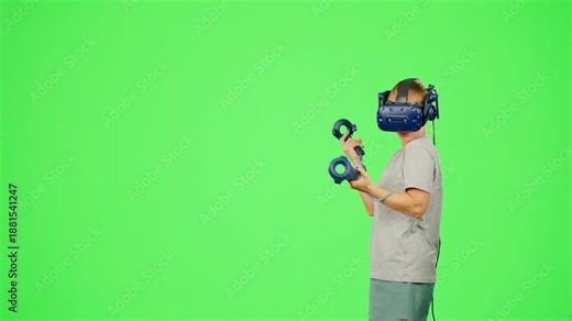 The woman wearing VR headset dancing in virtual reality.The girl on chroma key green screen background.Woman in virtual reality dancing.Concept dance in VR headset leisure activity in virtual reality