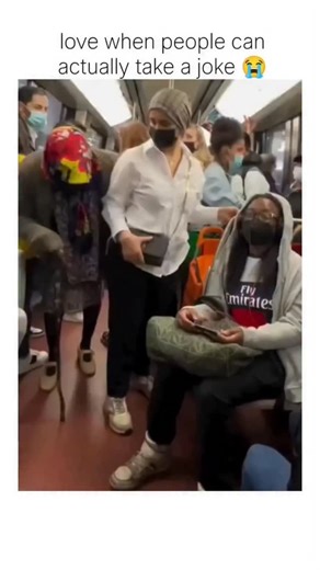wasted on Instagram: "The post features a 43-second video from a crowded subway train, capturing a playtul prank where a young man in a hoodie jokingly interacts closely with an elderly woman using a cane, leading to shared laughter among diverse passengers, emphasizing lighthearted intergenerational bonding. Posted on December 5, 2025, by , a account curating viral internet moments, the clip garnered over 86,000 views and 7,000 likes within hours, with replies praising respect for elders and th