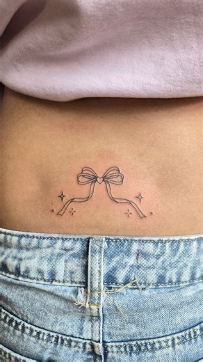 A cute little tramp stamp 🎀✨️ #finelinetattoo #daintytattoo #minimalisttattoo #seattletattoo #seattletattooartist #seattleart #sparkletattoo | Bone Broth