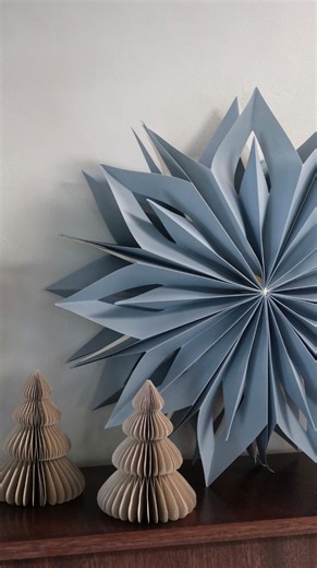 B&Q on Instagram: "ad Bringing a Modern Fairytale moment into my home this year with @bandq_uk A soft Scandi palette of blue and white, paired with frosted foliage and those beautiful paper stars and trees, creates a festive look that still feels calm, cosy and quietly magical. My unexpected styling tip: add one sculptural element to your tree for a quiet, fairytale moment. I’ve used protea this year for a soft, modern twist. And the scent… anything with frankincense instantly brings that warm D