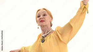Dancing senior woman isolated. Lady with raised arms. Former ballet dancer.