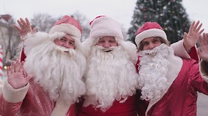 Three funny Santa Clauses waving at the camera on christmas day - Free Stock Video