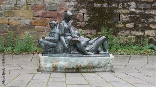 The Robin Hood statue stands proudly on Castle Road in Nottingham, England, aiming his arrow toward the historic gatehouse of Nottingham Castle.