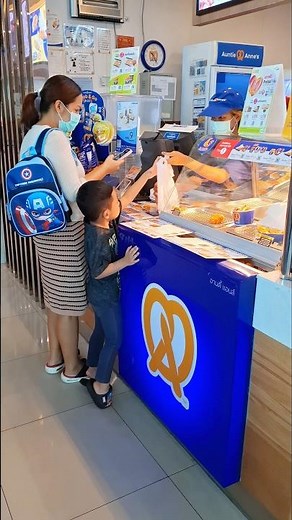 Mommy is teaching our child how to order snacks for the first time at Auntie Anne's! #familyactiv...
