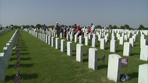 Volunteers to place flags at Fort Sam Houston National Cemetery for Memorial Day