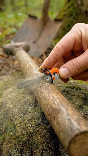 Ultra-realistic macro shot of an extremely tiny micro orange chainsaw cut a spade into Two parts.