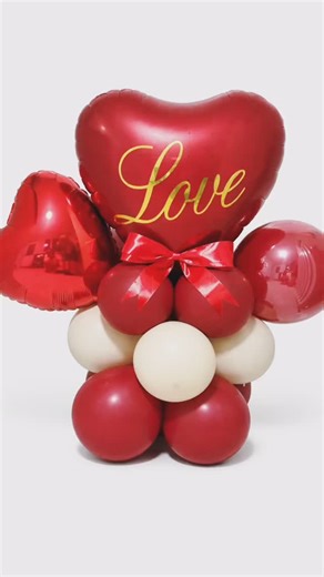 Balloons and Party Supplies in Lagos on Instagram: "Make their heart pop this Valentine’s Day with this stunning deluxe large “Love” heart balloon stack, the ultimate gift to show your affection. This eye-catching display features a large red heart foil balloon with elegant gold script, perfectly complemented by a mix of red and cream latex balloons and a charming red bow, making it a perfect add-on to any sweetie’s gift. Delivered fully inflated and ready to display, this impressive balloon col