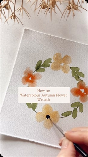 How to: Watercolour Autumn Flower Wreath 1. Draw a pencil circle 2. Paint four small orange dots on the left 3. Use a wet brush to pull the dots out into petals 4. Repeat on the right. 5. Tap Orange straight from the palette at the centre of the petals. 6. Repeat these steps but in yellow for flowers at the top and bottom. 7. With green on your brush, flatten and drag the belly of the brush on the paper to create leaf shapes in-between the flowers. 8. Connect the leaves with a thin line. 9. Pain