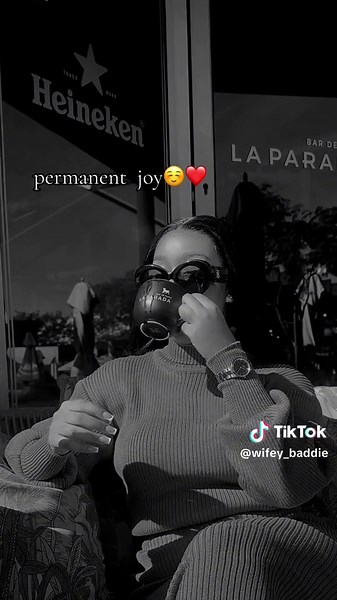 Enjoying Heineken Beer at a Cozy Café