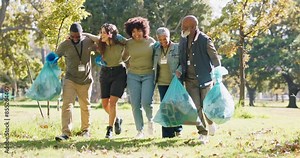 Happy, plastic bag or people in park walking for waste management or recycling in community service. Group, teamwork or proud volunteers cleaning garbage, junk or rubbish for nature sustainability