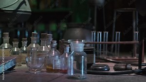 Corked Potion Bottles And Glass Tubes Inside An Alchemy Witch Laboratory. closeup, tilt-up