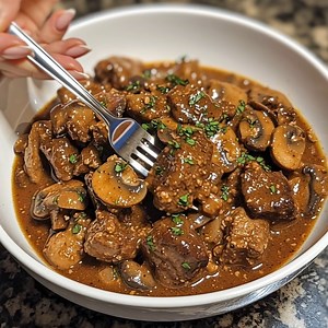 Beef Tips with Mushroom Gravy Tender beef tips simmered in a savory mushroom gravy for the ultimate comfort meal. This dish is hearty, rich, and perfect served over mashed potatoes, rice, or egg noodles. Ingredients: 2 lbs beef stew meat, cubed 2 tbsp olive oil 1 large onion, diced 3 cups mushrooms, sliced 3 cloves garlic, minced 3 cups beef broth 2 tbsp Worcestershire sauce 2 tbsp flour (or cornstarch for thickening) 2 tbsp butter Salt and black pepper, to taste Fresh parsley, chopped (for garn