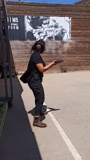 Shooting Range Action: Woman Practices Handgun Skills