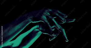 female hands moving in black background, closeup of palms, split of picture and changing colors