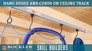 Clean up the clutter and hazards in your shop caused by loose cords, hoses, and cables on the shop floor or benches. The Rockler Ceiling Track System features hooks that keep your cords and hoses off the ground, but roll freely along a ceiling track so you can sand, saw and rout without fighting with them. They can also be used to hang doors for finishing or to hang tools and utility lights. Ceiling track Starter Kit: https://www.rockler.com/starter-kit-for-rockler-ceiling-track-system | Rockler