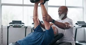 Friends, dumbbells and old men in gym, fitness and exercise with personal trainer, strong and warm up. Health, equipment or retirement with training, endurance and challenge with progress or wellness