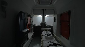 Internal view of a modern ambulance car riding on the street Interior, modern special equipment, seat and stretcher