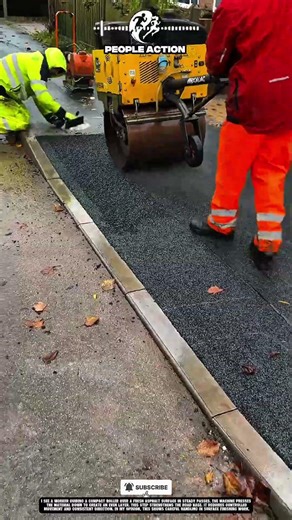 Construction People Compacting Asphalt Surface During Roadwork Action